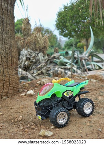 A vertical selective focus shot of a toy car at the park
