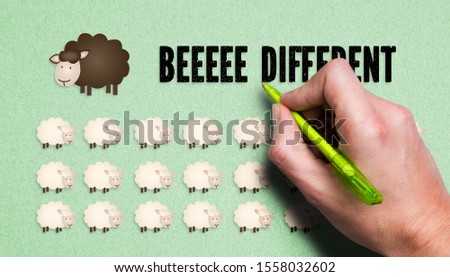 hand drawing black sheep in the middle of many white sheeps on paper background
