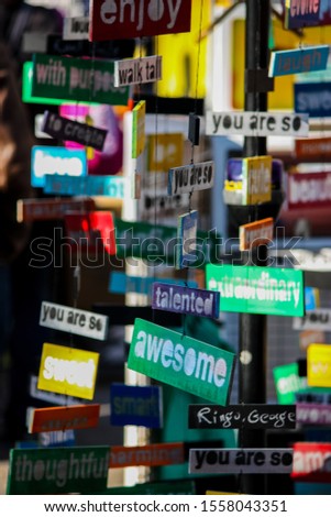 many small hanging signs and very colorful with different messages like, awesome, you are so, enjoy, sweet and more