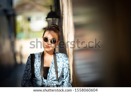 Happy woman wearing a sunglasses  with lovey light and shadow, (toned image)