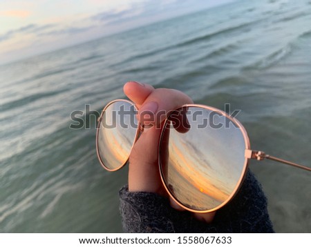 I took this picture in cape cod at mayflower beach! Loved the reflection of the sunset on the sunglasses and had to snap a photo!