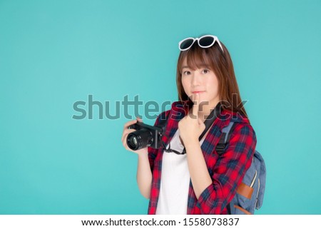 Beautiful young asian woman thinking idea travel trip summer isolated on blue background, asia girl having activity hobby take a photo holding camera, tourist journey in vacation and holiday.