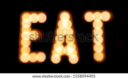 The word "eat" written by light bulbs. Street sign