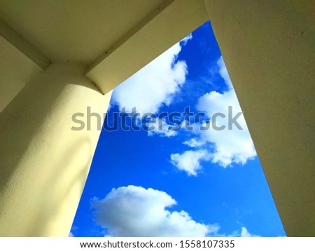 Columns building. Blue sky with clouds