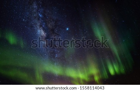 Abstract Night photo with Milky Way and Aurora for background.