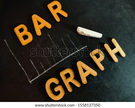 bar graph diagram making on chalkboard with wooden alphabet form 