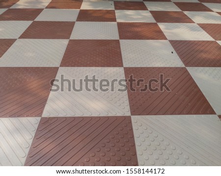 brown and off white square tiles. textured background.