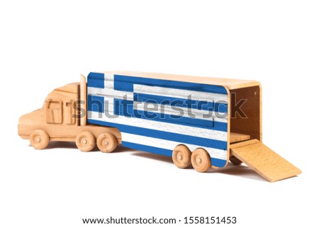 Close-up of a wooden toy truck with a painted national flag Greece. The concept of export-import,transportation, national delivery of goods 