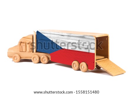 Close-up of a wooden toy truck with a painted national flag Czech. The concept of export-import,transportation, national delivery of goods 