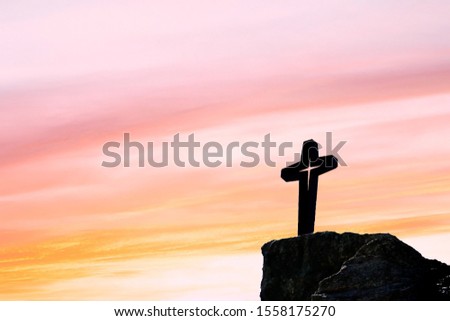 Silhouette of Jesus christ crucifix on cross over sunset.Concept for Catholic religion, Christian worship, Christmas, Easter Day, Bible,Thanksgiving prayer and praise good Friday.