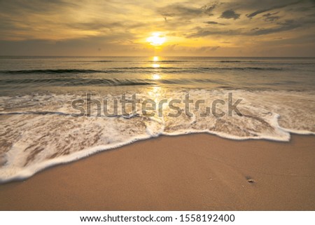 beautiful seascape  the sun light and the sea wave bubble on the sand at morning time Chumphon beach sea Thailand long exposure shot