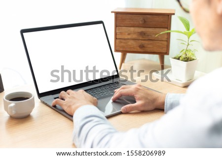 mockup image blank screen computer with white background for advertising text,hand man working using laptop contact business search information on desk in office.marketing and creative design
