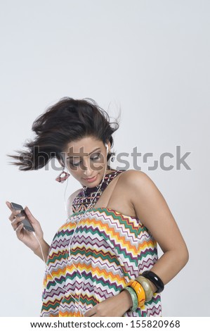 Woman listening to music and dancing Royalty-Free Stock Photo #155820968