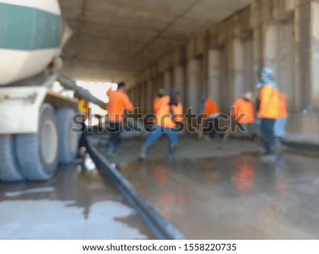 Workers make concrete roads in tunnels (blurred images)