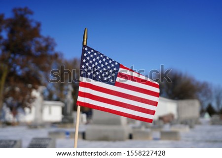 American flag stands in the cold windy weather 