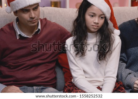 daughter little girl and father unhappy and upset moody emotion on christmas day in living room that decorated for christmas festival day