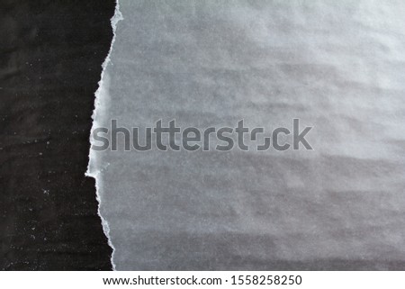 Black and silver grey crumpled, ripped and peeling old shabby paper posters with dirty traces of glue texture background. Can be used for text. Royalty-Free Stock Photo #1558258250