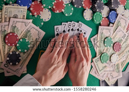 to a poker player in a casino, a combination in straight cards, a lot of money and chips