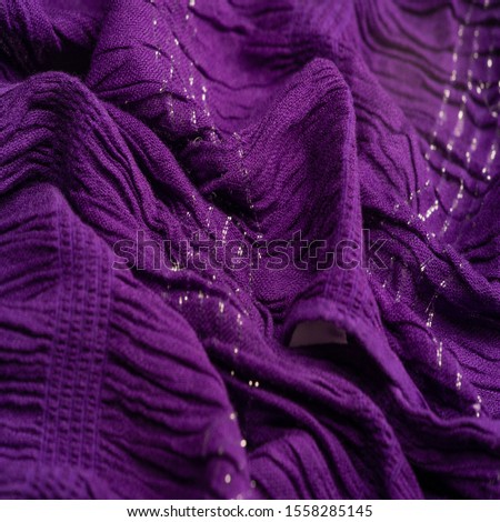 Texture background pattern, decor ornament, dark lilac corrugated fabric of blue cent, Fabric with parallel or diagonal folds of dentate folds; products from such a fabric.