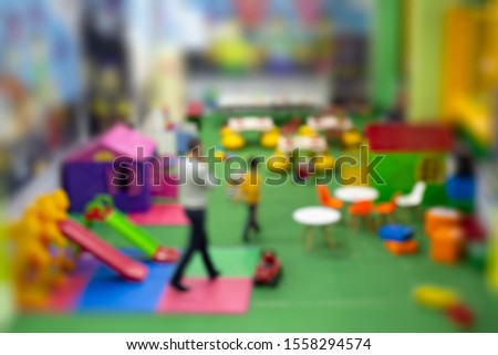 Playroom or Kindergarten Blurred background. Blurred image of son and dad in Children's Commercial Indoor Playground.