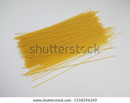 The picture shows spaghetti, a pasta dish ingredient, on a white background.