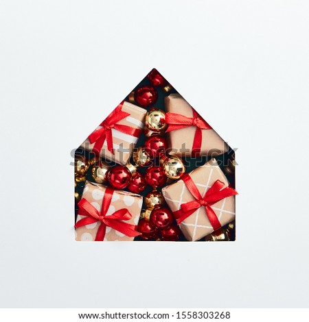 Christmas minimal concept - christmas house silhouette made of bauble and xmas gifts. Flat lat, top view. Square composition. Minimal concept. Christmas gift box.