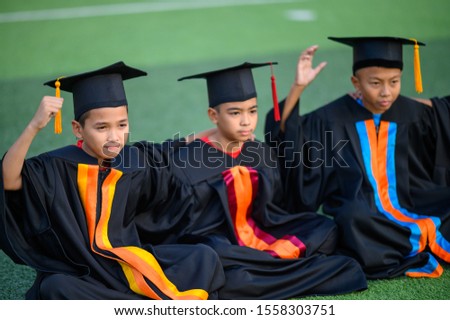 A group of boys are happy on their graduation day at school.