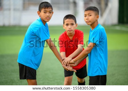 Boys playing football on the football practice field