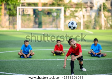 Boys playing football on the football practice field