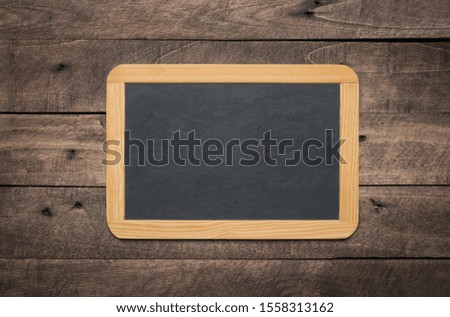 Blank small chalkboard on an old rustic background, close up