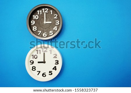 Top view of alarm clocks with different time Flat lay composition