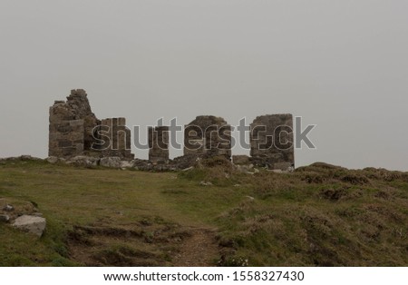 Remains of the Ruin of the Iron Age Kenidjack Castle Surrounded by Sea Mist on top of Penwith Peninsula on the South West Coast Path between Pendeen Watch and Sennen Cove