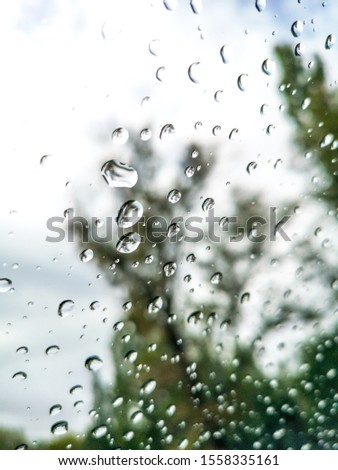 Drops of rain on a car glass as a background.