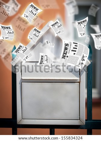 Post box with daily newspapers flying out
