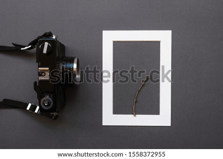 analog camera and frame on work desk