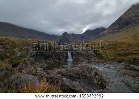 This is a picture from the Scottish Highlands on a cloudy day showing a waterfall near the Fairy Pools. 