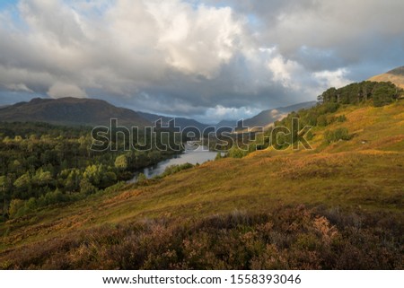 This is a picture from the Scottish Highlands on a cloudy day showing the autumn colored valley of Glen Affric. 
