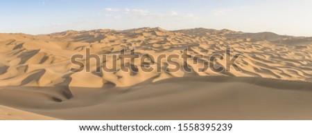 Kumtag Desert, China - a section of the wider Taklamakan Desert, and part of the Tarim Basin, the Kumtag Desert is famous for it's sandy dunes and the beauty of its landscape Royalty-Free Stock Photo #1558395239
