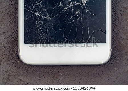 Mobile smartphone with broken screen close up
