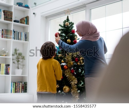 Arabic family with New year holidays tree
