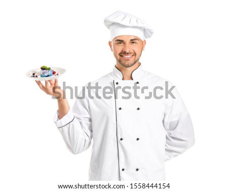 Male confectioner with tasty dessert on white background