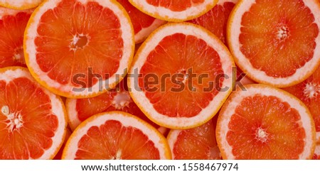 Fresh red juicy swee sliced grapefruit - citrus background