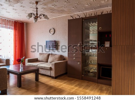 Interior of typical soviet style apartment. Old furniture and retro design in the living room