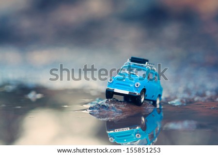 Miniature travelling car with luggage on top. Macro photography