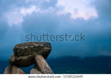 Dolmen called Chabola de la Hechicera with mountains in the background and clouds during sunset, in Alava, near Laguardia, Basque Country, Spain