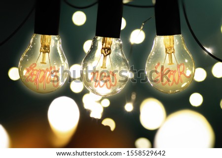 Happy new year. Holiday card. Filament lamps with text happy new year. Cozy image. Hygge mood.