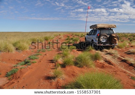 Four wheel drive vehicle picking way through the multiple red dirt tracks of the Canning Stock Route Western Australia  Royalty-Free Stock Photo #1558537301