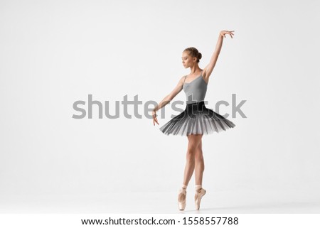 Ballerina in pointe and tutu on an isolated background