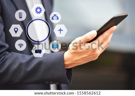 Businessman holding cell phone using Mobile phone or Smart phone Telephone to call phone with Social media Icon technology by WiFi internet  Network digital