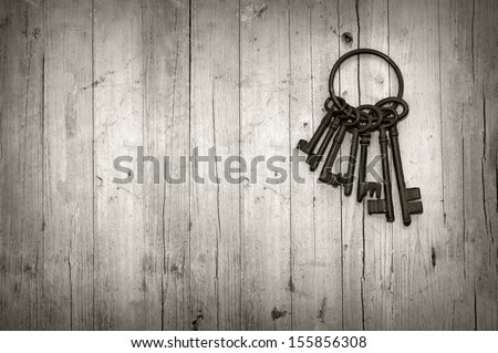 bunch of old keys on wooden background black and white Royalty-Free Stock Photo #155856308